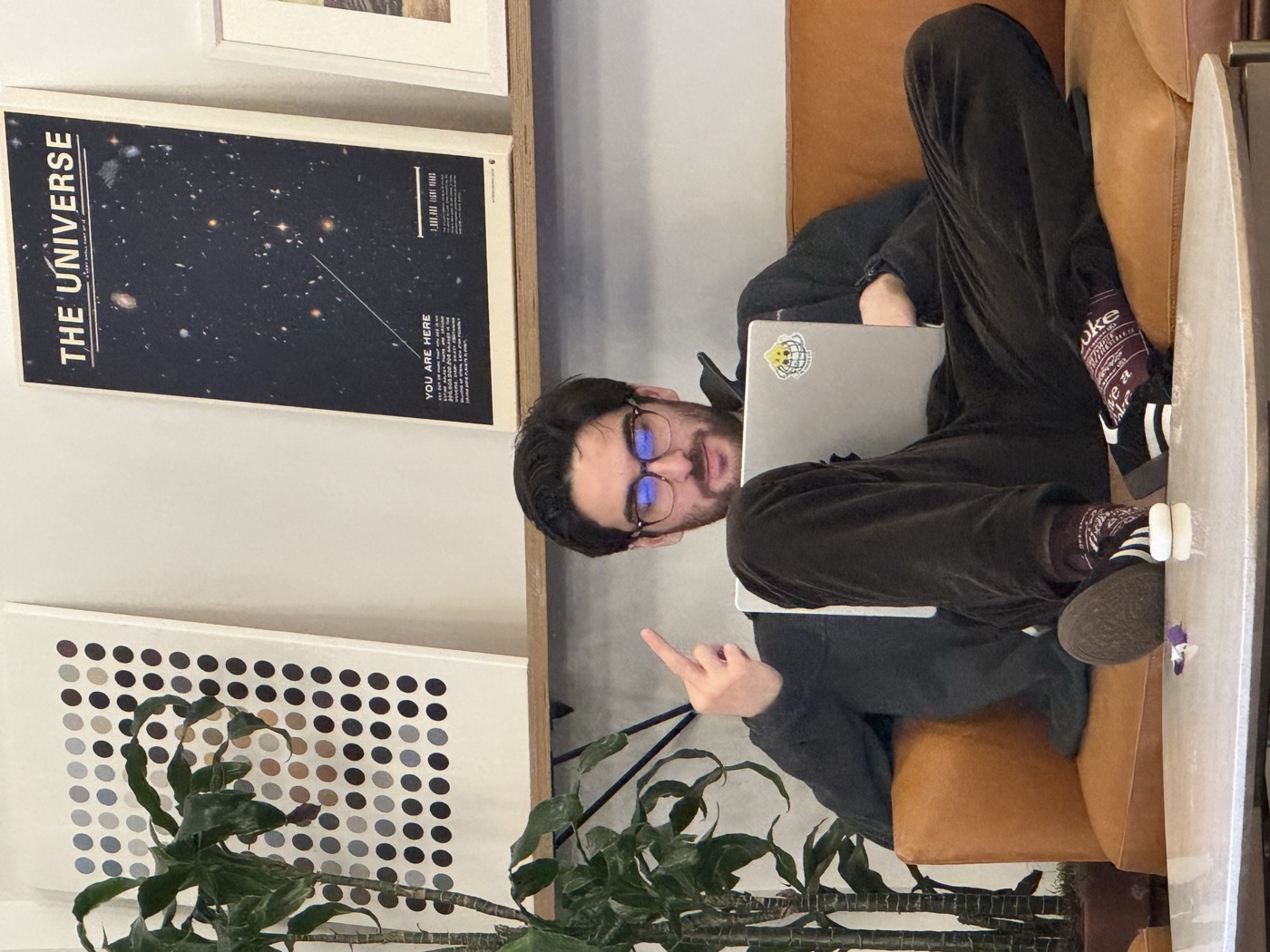 Halil sitting with a laptop